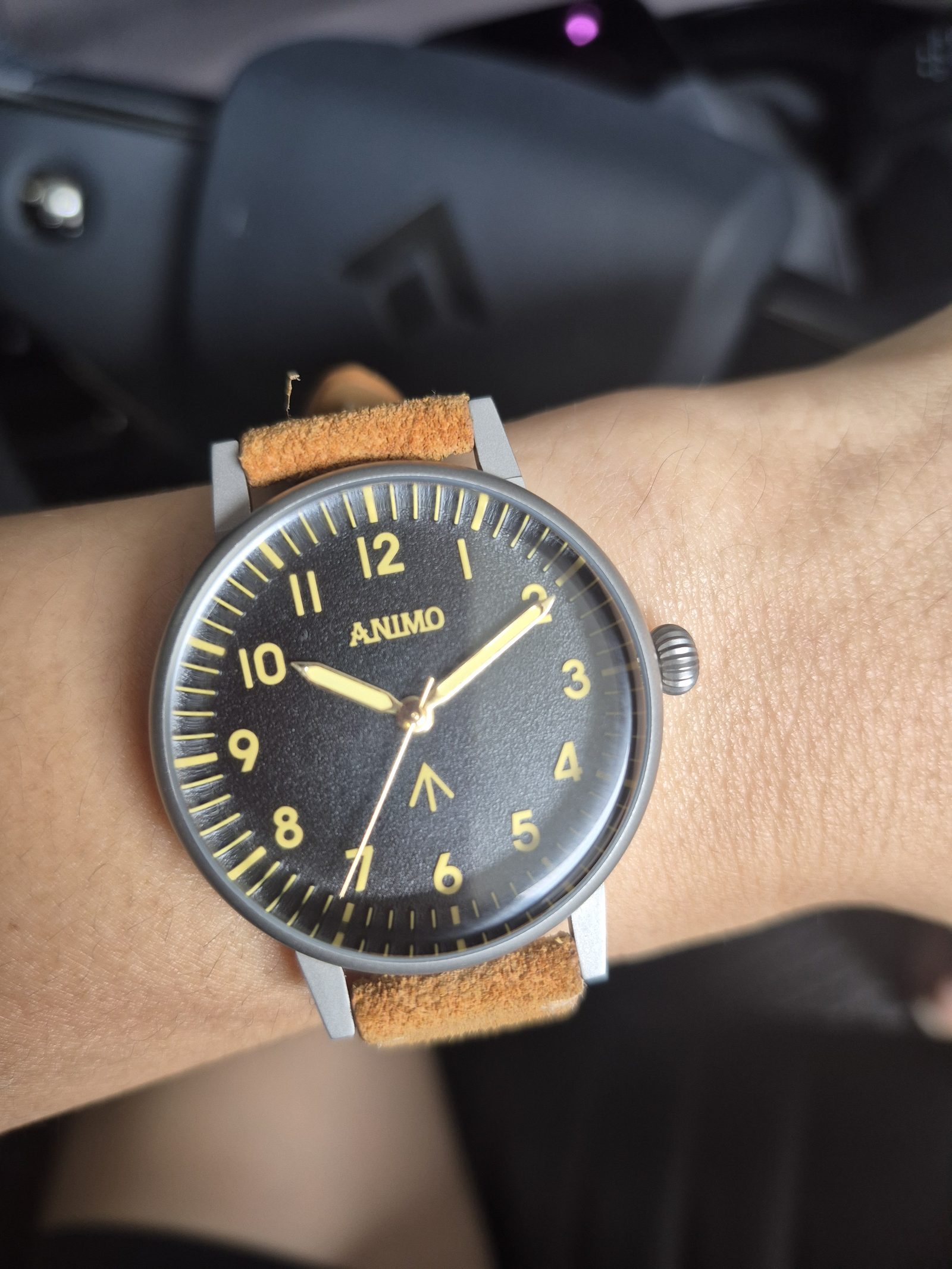 ANIMO Field Watch, Noir Gold, worn on the wrist — real production photo